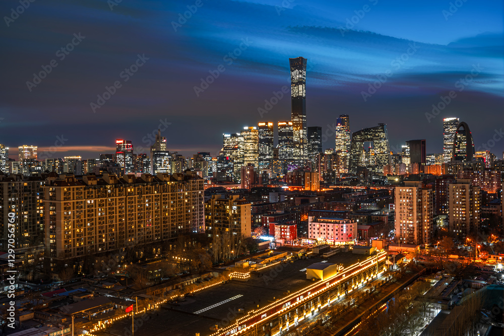 Fototapeta premium The brightly lit skyscrapers and residential areas in the night view of Beijing, China
