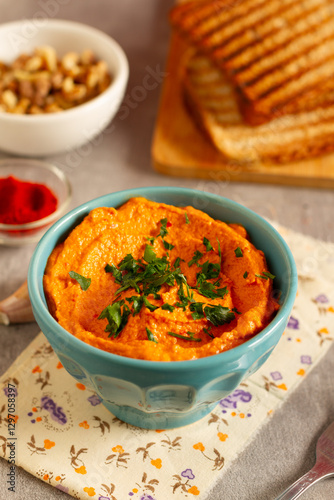 Wallpaper Mural A bowl of red pepper and walnut dip served with bread chips on a plate Torontodigital.ca