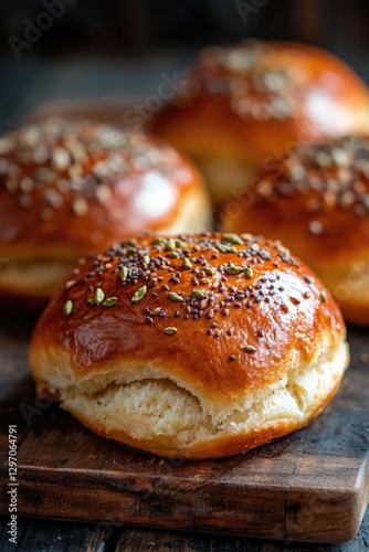 A simple wooden cutting board with two buns on top, perfect for serving or displaying