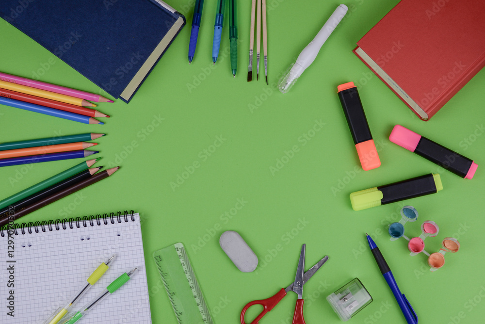 A bright green table adorned with a diverse assortment of school supplies A bright green table adorned with a diverse assortment of school supplies