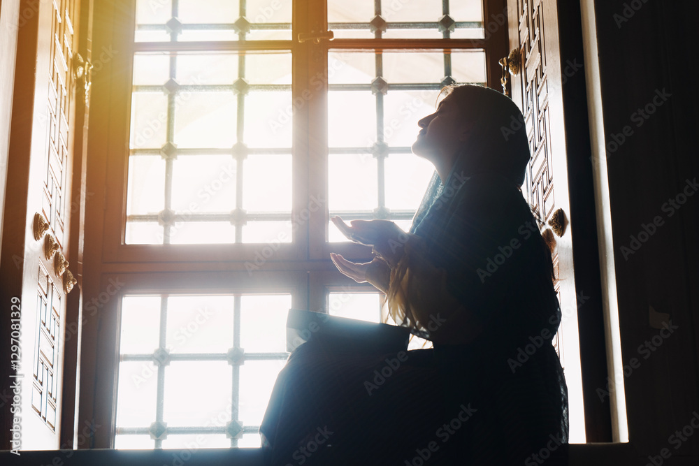 Muslim woman in headscarf and hijab prays with her hands up in air in mosque.Religion praying concept. Muslim woman in headscarf and hijab prays with her hands up in air in mosque.Religion praying concept.