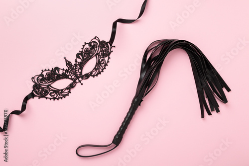 Set of erotic BDSM accessories on color background, top view photo
