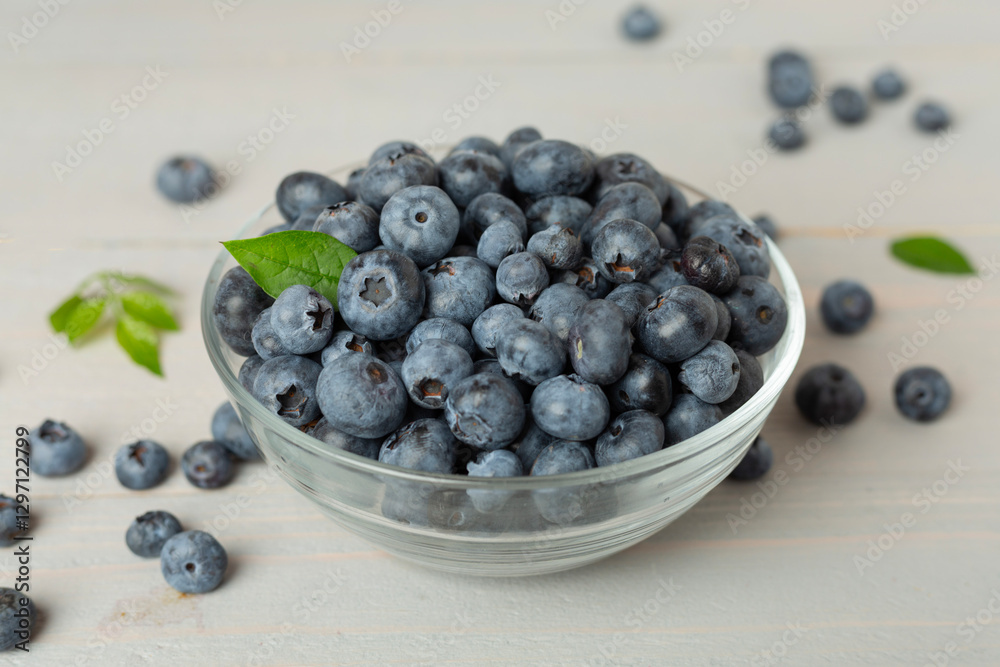 Bowl with fresh bright blueberries on wooden table Bowl with fresh bright blueberries on wooden table
