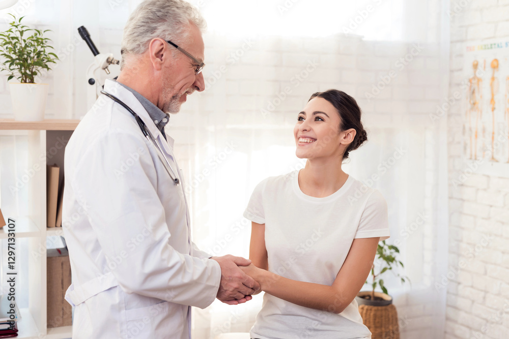 Obraz premium Doctor with stethoscope and female patient in office. Doctor is examining woman's head.