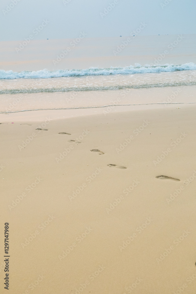 Footprints of human feet on the sand near the water on the beach. Footprints of human feet on the sand near the water on the beach.