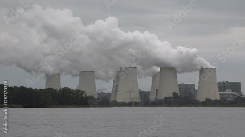 Cooling towers of coal fired plant billow smoke at Janschalde power station in Eastern Germany, air pollution and global warming Europe
