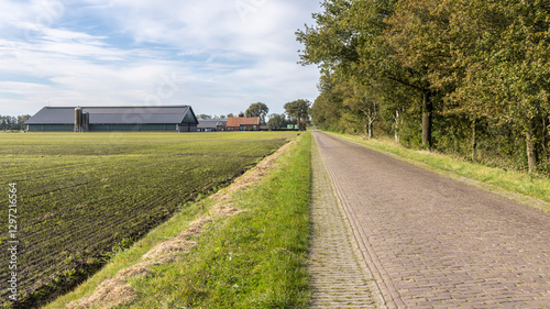 Old farmhouse with large modern stables with solar panels at the countryside of Drenthe The Netherlands