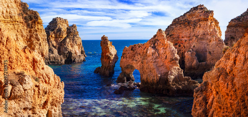 Amazing rocky scenic becahes of Algarve coast, Portugal. Breathtaking  famous beach Praia da marinha with yellow rocks with arc .  panoramic view