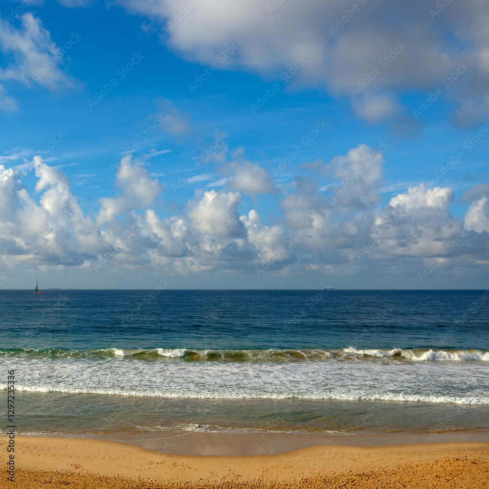 Clear sunny day at seaside. Yellow sand and blue ocean Clear sunny day at seaside. Yellow sand and blue ocean