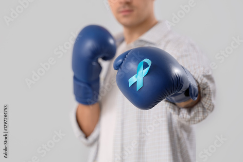 Young man in boxing gloves ...