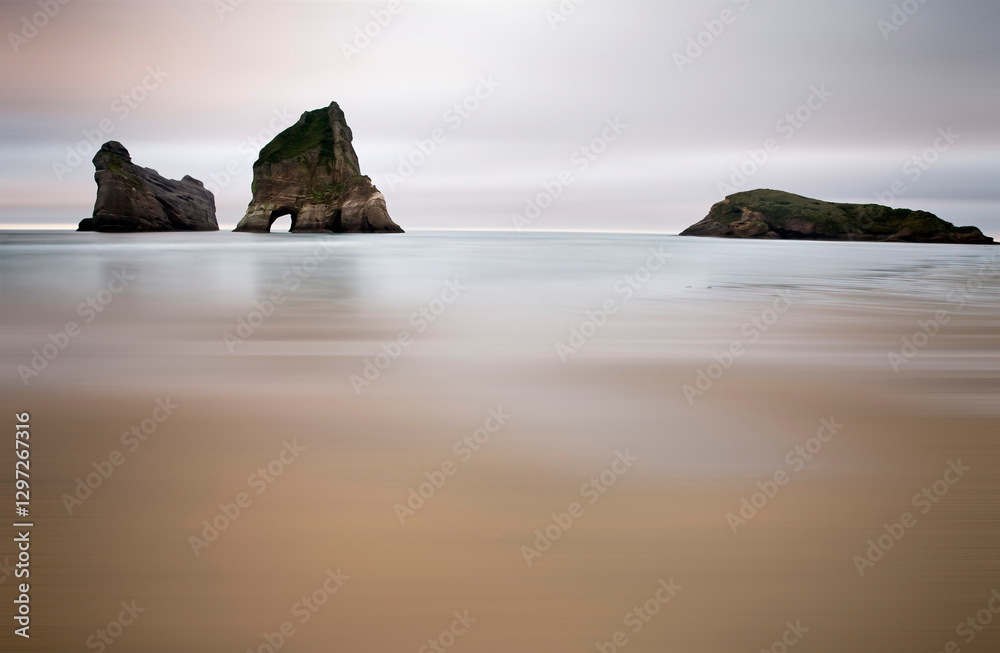 Wharariki beach showing archway islands at dawn