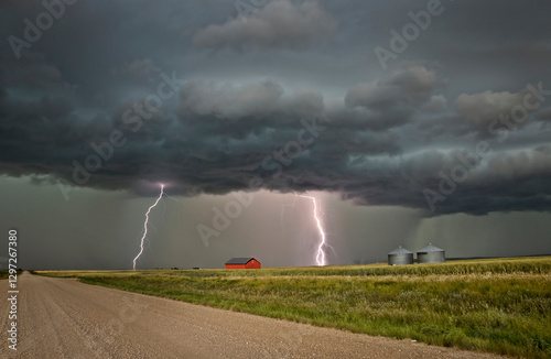 Obraz na płótnie Lightning strikes illuminate a rural landscape during a dramatic storm w salonie