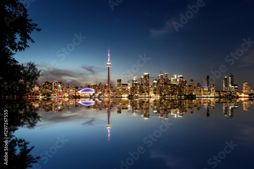 Toronto skyline reflecting at twilight over lake ontario