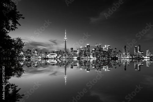 Toronto skyline reflecting in lake ontario at night in black and white