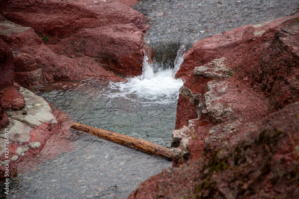 Red rock canyon stream flowing over waterfall