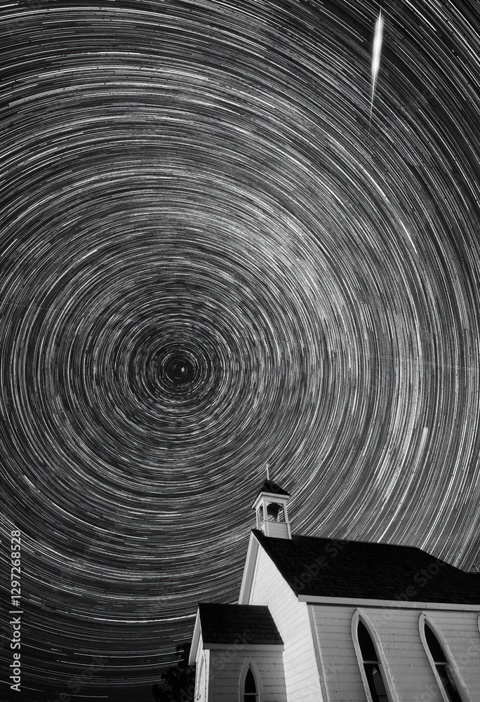 Star trails rotating over a country church at night
