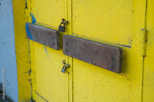 Wallpaper Mural A metal door with wooden bars closed with two padlock
 Torontodigital.ca