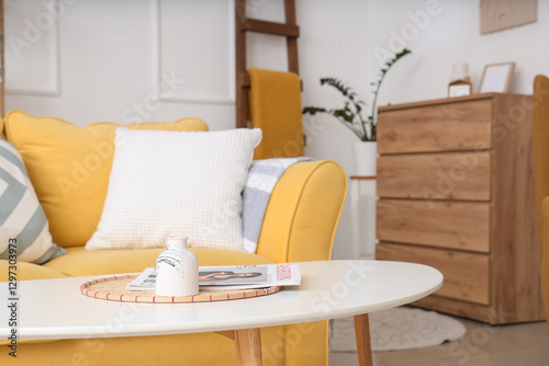 Vase with magazine on table...