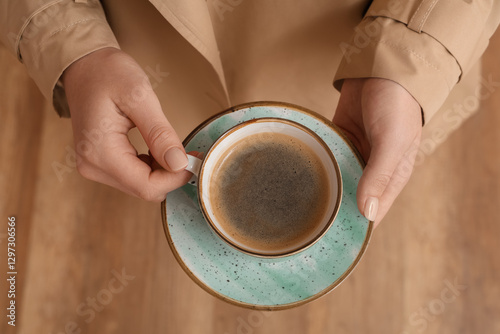 Woman holding cup of coffee...