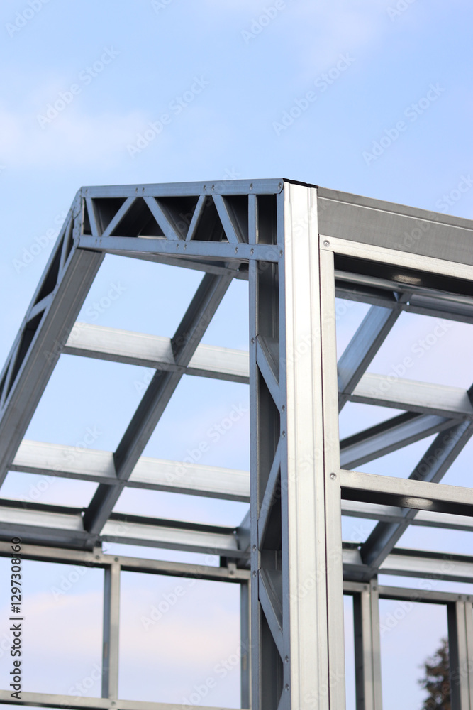 Lightweight steel thin-walled structures. Frames for warehouses, garages or houses. Structure of a steel frame for construction against the sky