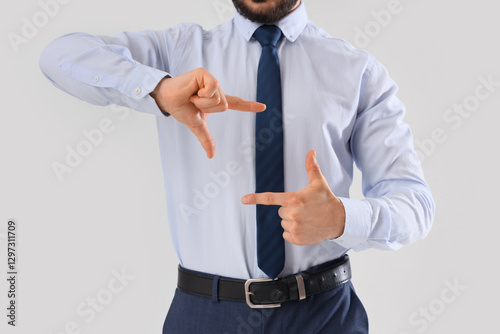 Businessman showing frame g...