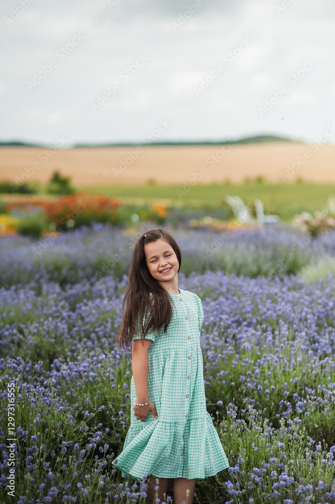Happy smiling daughter enjoying vacation in flower field.A cheerful girl is jumping from the bottom down. Happy smiling daughter enjoying vacation in flower field.A cheerful girl is jumping from the bottom down.