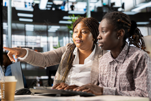 African american corporate team focuses on data management, planning strategies for company growth and aligning business goals with performance metrics for measurable success.