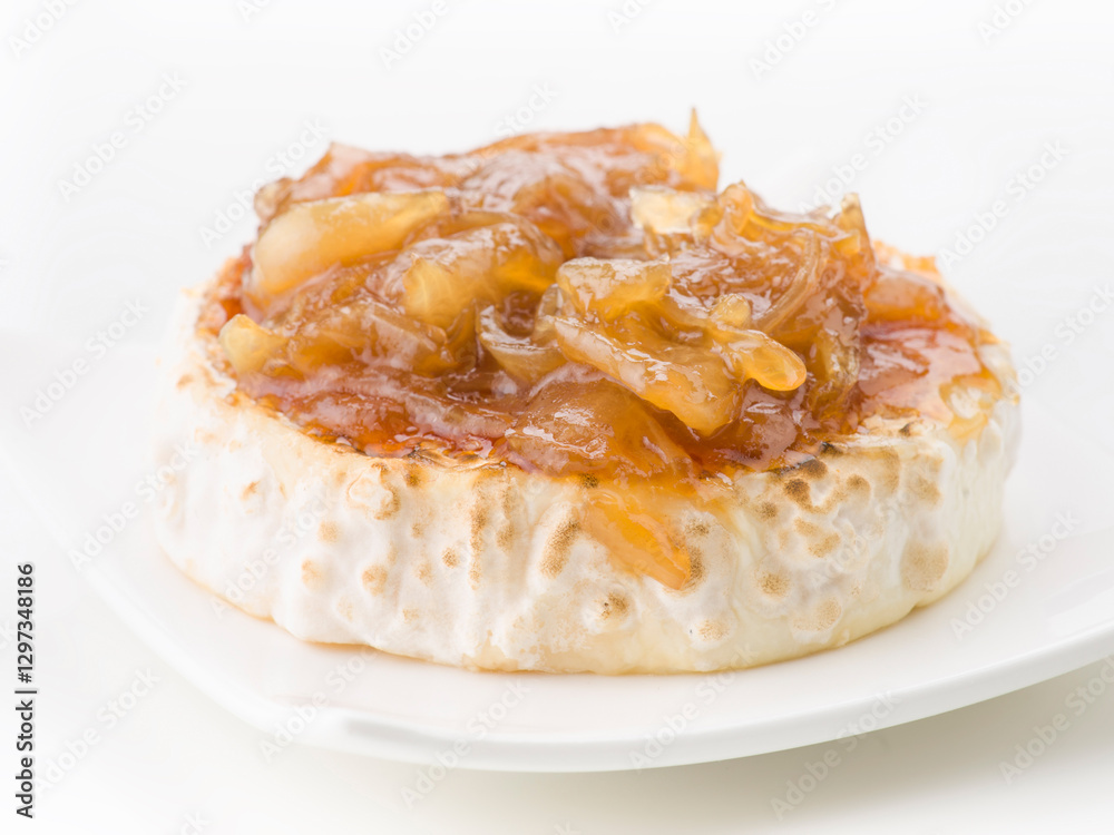 Goat cheese covered with caramelized onion on white background Goat cheese covered with caramelized onion on white background