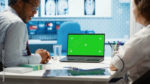 Wallpaper Mural Medical expert pointing at isolated chroma key display in cabinet, doing a scan interpretation for disease diagnostics and test analysis. Professional medic supports her patient. Camera A. Torontodigital.ca