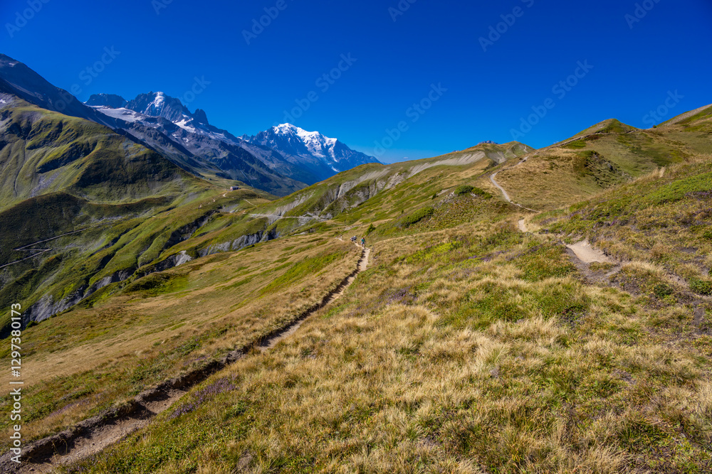 Obraz premium Alps scenic landscape on Tour du Montblanc. Rocky and snow summit peaks of the Alps on the trekking route TMB around Mont Blanc in Chamonix and Courmayeur. Alpine scene with mountains and lakes