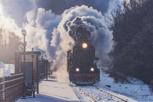 Retro train arrives to the platform at winter morning. photo