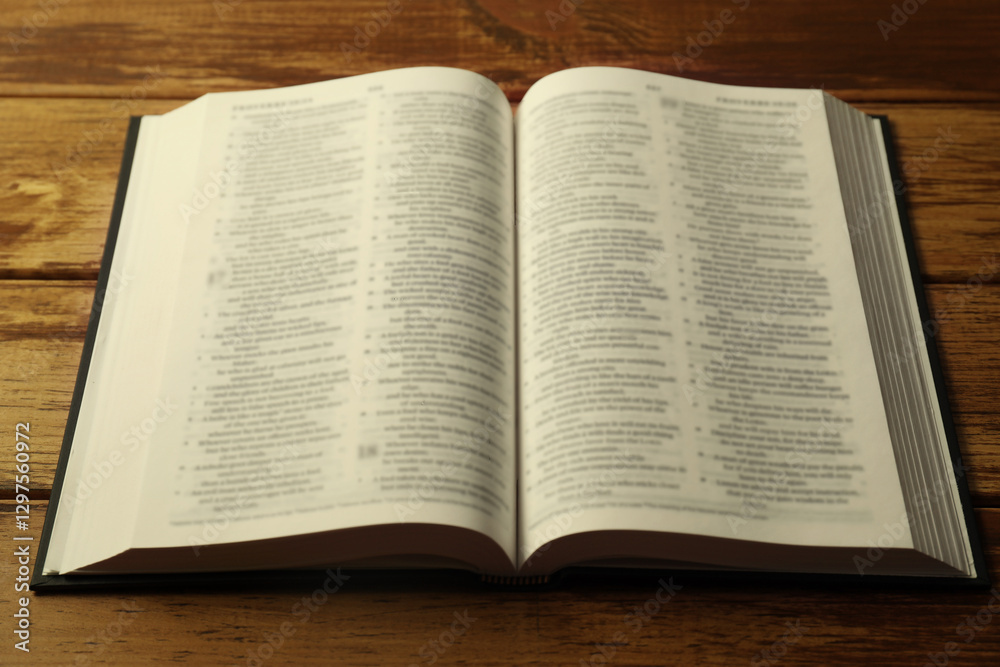 Open Holy Bible in English language on wooden table, closeup Open Holy Bible in English language on wooden table, closeup