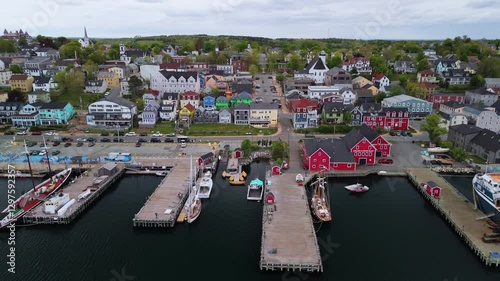 Aerial Footage Of The Historic Town Of Lunenburg, Nova Scotia, On A Cloudy Summer Day. The Scenic Coastal Views And Vibrant Buildings Showcase The Charm Of This UNESCO World Heritage Site.