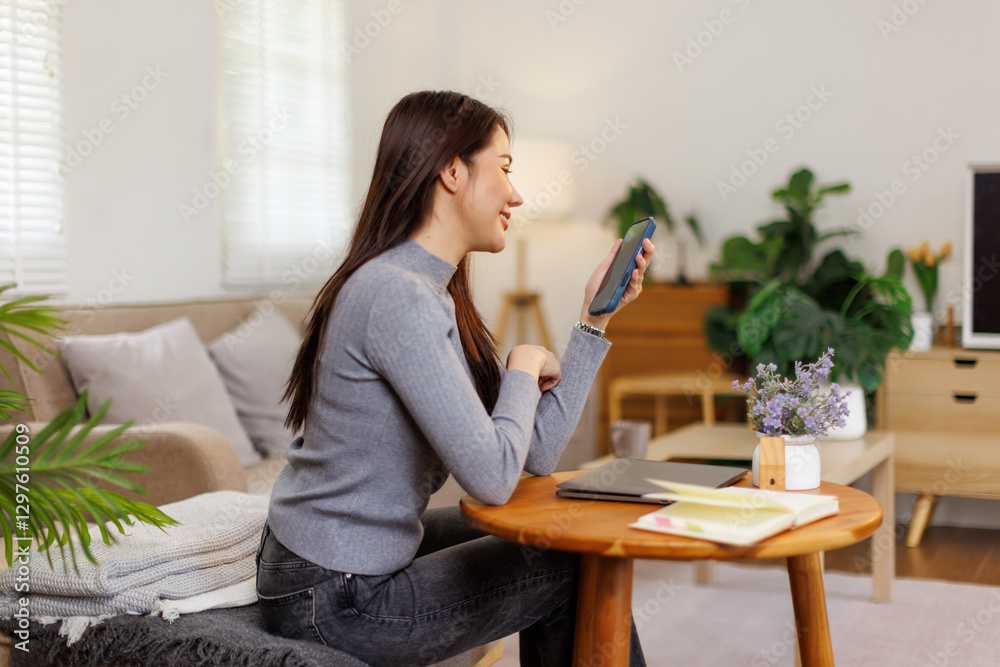 Beautiful asian businesswoman or female executive manager sits at her worktable and uses a smartphone.
Beautiful asian businesswoman or female executive manager sits at her worktable and uses a smartphone.
