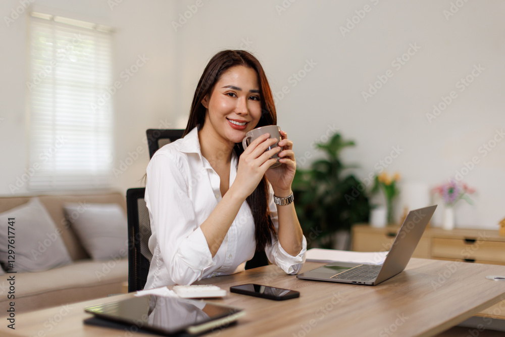 Asian female hand holding coffee cup with laptop financial management and checking planning and online at home office
Asian female hand holding coffee cup with laptop financial management and checking planning and online at home office