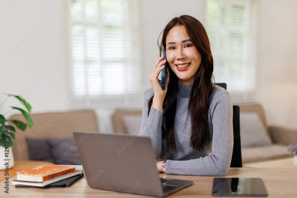 Phone conversation. Confident young asian woman at work from home.Teen female make answer call using cell listen to friend parent. Copy space Phone conversation. Confident young asian woman at work from home.Teen female make answer call using cell listen to friend parent. Copy space