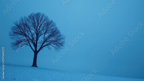 Serene Winter Landscape A Lone Deciduous Tree Stands Silently on a Snow-Covered Hill Under a Pale Blue Sky