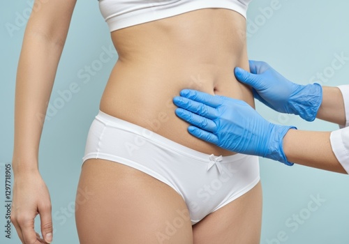 closeup of doctor checking belly of female patient