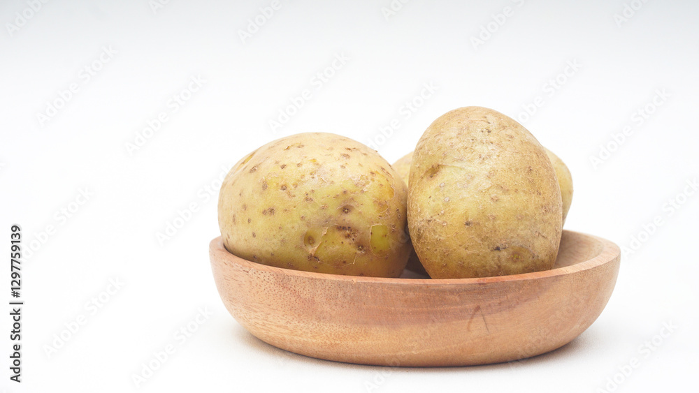 Potatoes on Wooden Plate Isolated on White Background Potatoes on Wooden Plate Isolated on White Background