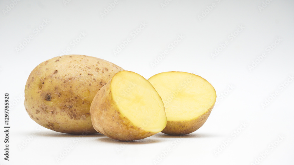 Whole and Two Halves Cut of A Potato Isolated on White Background Whole and Two Halves Cut of A Potato Isolated on White Background