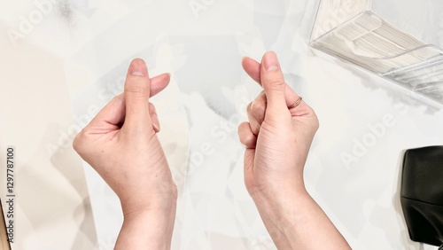 hands of a woman with fingers korean heart