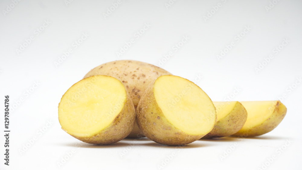 Whole, Two Halves Cut, and Slices of A Potato Isolated on White Background Whole, Two Halves Cut, and Slices of A Potato Isolated on White Background