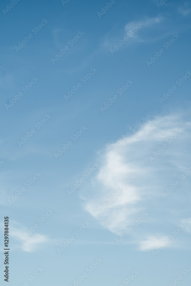Obraz premium This photograph captures a breathtaking view of the blue sky adorned with soft, white clouds