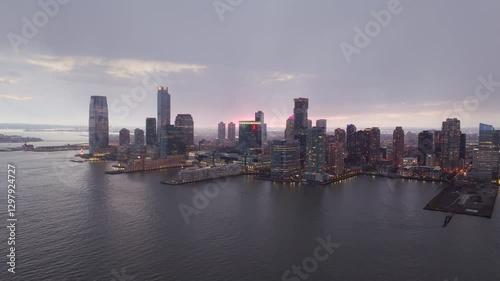 Wallpaper Mural Jersey City skyline reflecting golden sunset light across Hudson River, revealing illuminated skyscrapers and downtown architectural landscape Torontodigital.ca