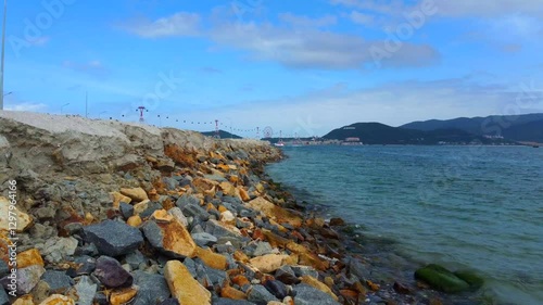 A small wild beach.

The outskirts of Nha Trang city in Vietnam. A cable car is visible in the distance. Taken from a drone.