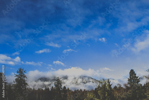 Wallpaper Mural Snow-capped mountain peaks under a bright, expansive blue sky. Torontodigital.ca