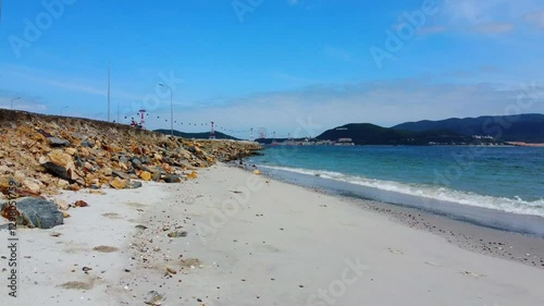 A small wild beach.

The outskirts of Nha Trang city in Vietnam. A cable car is visible in the distance. Taken from a drone.