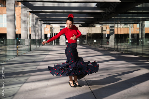 Flamenco dancer performing outdoors with skirt whirling