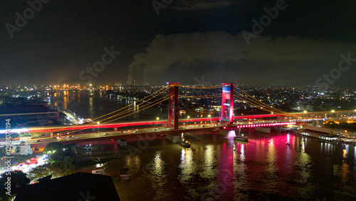 Aerial shot of Ampera Bridge at night, one of the landmarks of Palembang city, South Sumatra, Indonesia photo