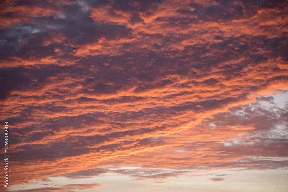 Fiery sunset clouds paint the evening sky in brilliant hues Fiery sunset clouds paint the evening sky in brilliant hues